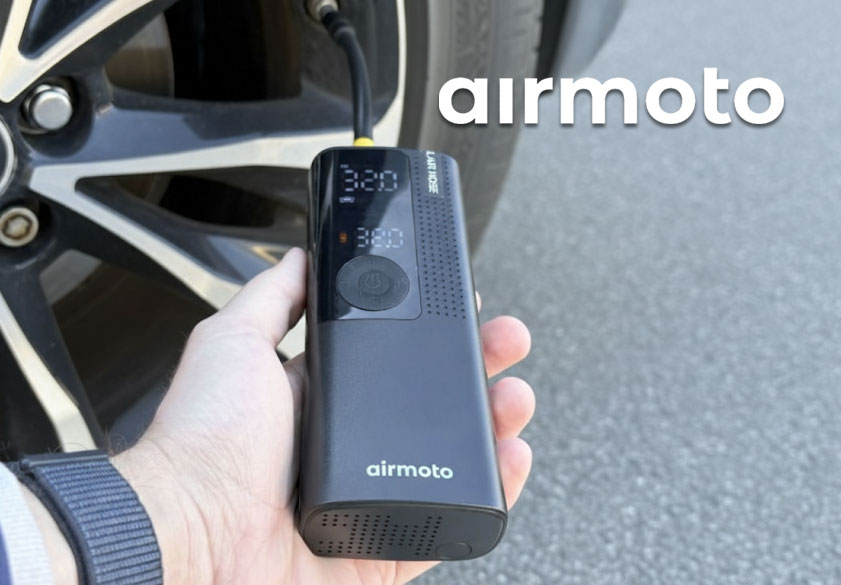 Driver using Airmoto tire inflator on car tire
