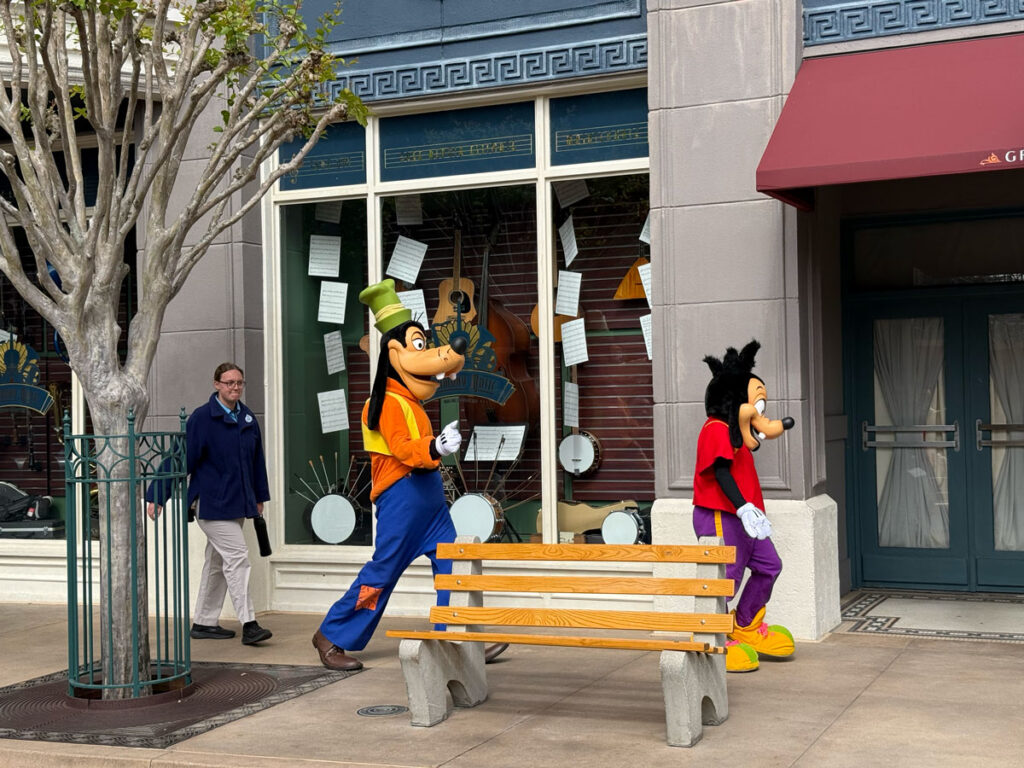 Goofy and Max walking past storefronts