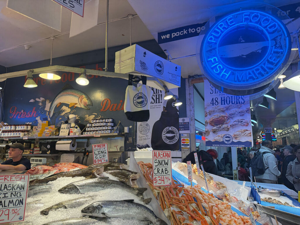 A glowing blue neon sign marks the Pure Food Fish Market