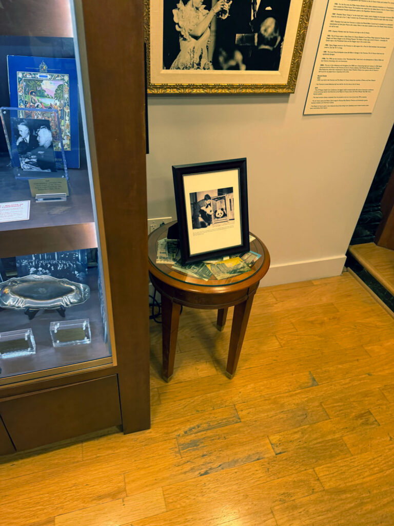 A framed historical photo and a printed timeline of the hotel's milestones